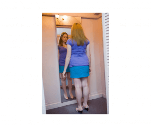 Woman checking her posture in a mirror