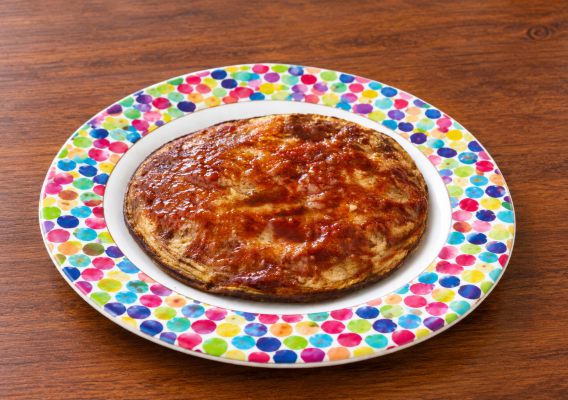 Glossy Glazed Pancake on Colorful Dotted Plate